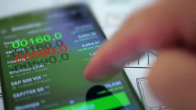 Businessman checking stock market data on a smartphone in 4K UHD, illustrating finance, investment, trading, digital technology, and business analysis. - Powered by Shutterstock - Get 15% off with code: PIKWIZARD15