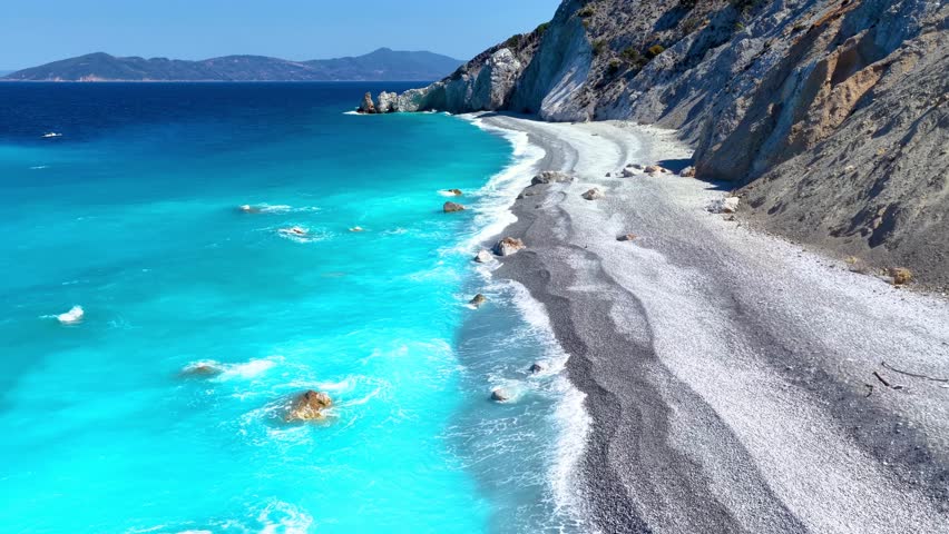 Aerial view of the famous beach at Lalaria, Skiathos, Greece, on a stormy day with shades of turquoise, shining sea and no people