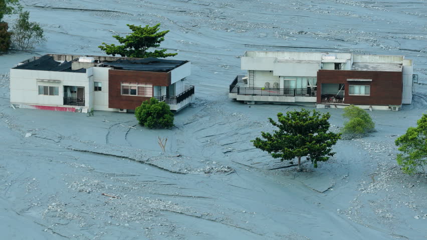 Aerial view of mud-covered houses after flooding