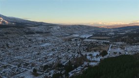 Drone slow pan over Esquel, Chubut—Argentina at sunrise reveals snow-covered rooftops, forested slopes, and golden light on La Torta and La Hoya peaks, framed by the Patagonian Andes - Powered by Shutterstock - Get 15% off with code: PIKWIZARD15