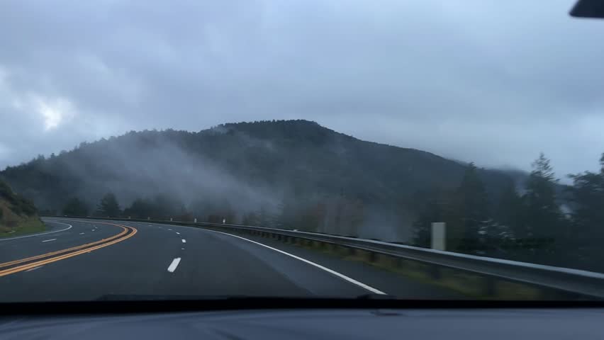 Car POV shot driving through a mountain forest in the fog on the Redwood Highway in Northern California. 4K