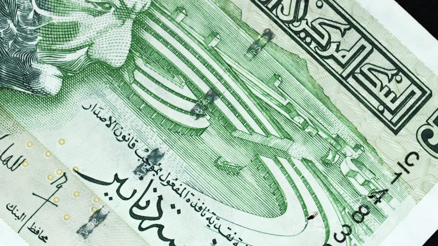 Tunisia 5 Dinar banknote obverse with Arabic script and amphitheatre engraving rotating on black background