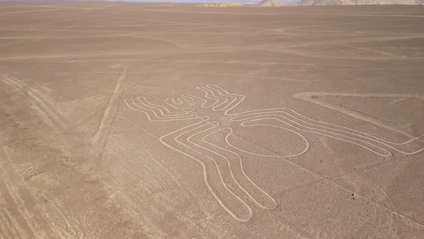 Aerial shot orbiting around the ancient Spider geoglyph one of the mysterious Nazca Lines etched into the desert floor in Peru