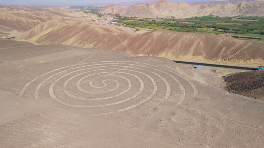 Aerial parallax view of the Nazca Lines spiral geoglyph in the desert landscape of southern Peru
