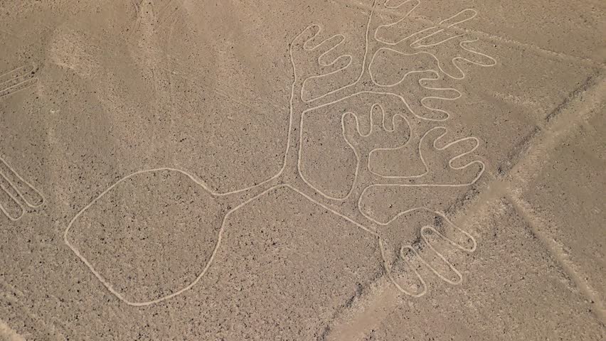Aerial parallax shot of the Tree and Hands figures one of the mysterious ancient Nazca Lines geoglyphs etched into the desert plateau of Peru