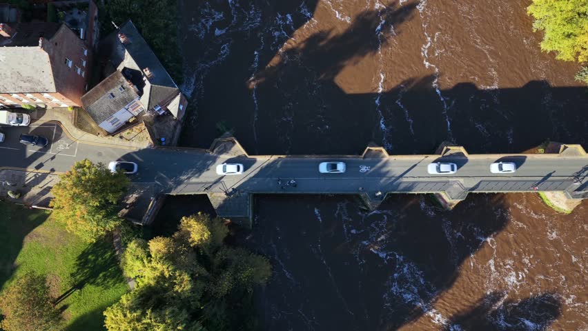 Top-down aerial view of Chester’s Old Dee Bridge crossing the River Dee near the Chester Weir.