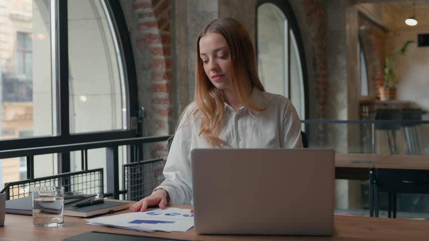 Joyful smiling Caucasian business woman female entrepreneur girl businesswoman having fun joy spinning rotate on office chair dancing showing thumbs up happy with corporate success documenting results