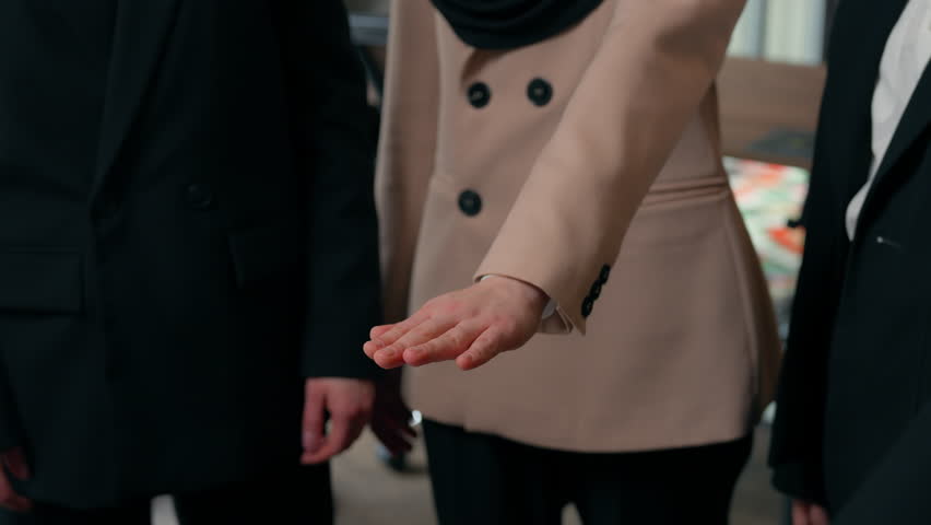 Three happy successful multiracial business women team girls females multiethnic colleagues businesswomen stack hands unity teamwork achieve applause Caucasian Asian Muslim ladies office collaboration