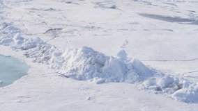 Vast polar sea ice scene featuring pressure ridges and turquoise melt ponds, with fractured floes, snow-covered surfaces, and frozen channels across a remote, frigid wilderness. - Powered by Shutterstock - Get 15% off with code: PIKWIZARD15