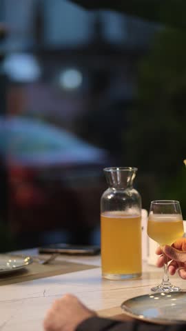 Homemade white wine in a jug and two glasses