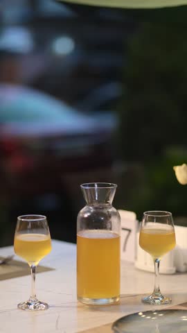 Homemade white wine in a jug and two glasses
