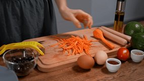 Woman preparing breakfast. Chopping vegetables, cucumber, carrot, tomato, avocado on board. - Powered by Shutterstock - Get 15% off with code: PIKWIZARD15