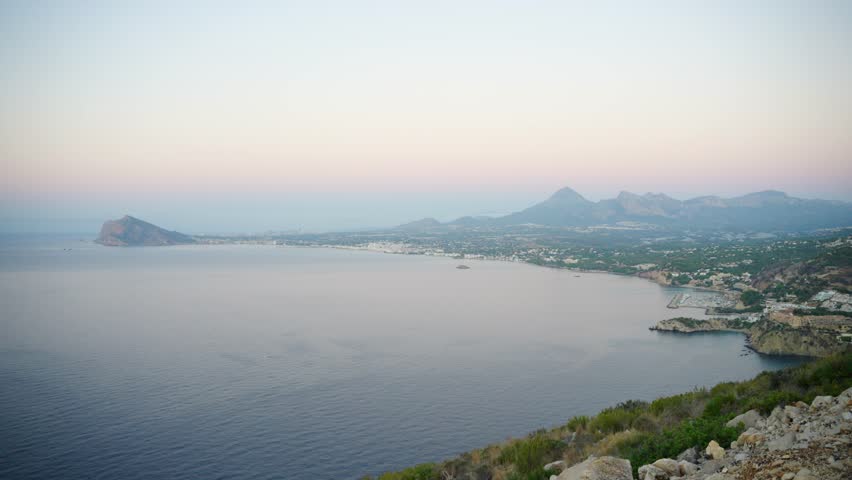 Calpe Coastline By The Mediterranean Sea Seen From Mirador De Carabiners, Viewpoint In Penyal d'Ifac Natural Park, Calp, Spain. - wide shot