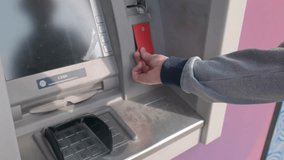 Man hand using contactless credit card with NFC at an ATM, entering PIN for cash withdrawal. Modern payment NFC technology, banking, financial transactions, security and digital finance - Powered by Shutterstock - Get 15% off with code: PIKWIZARD15