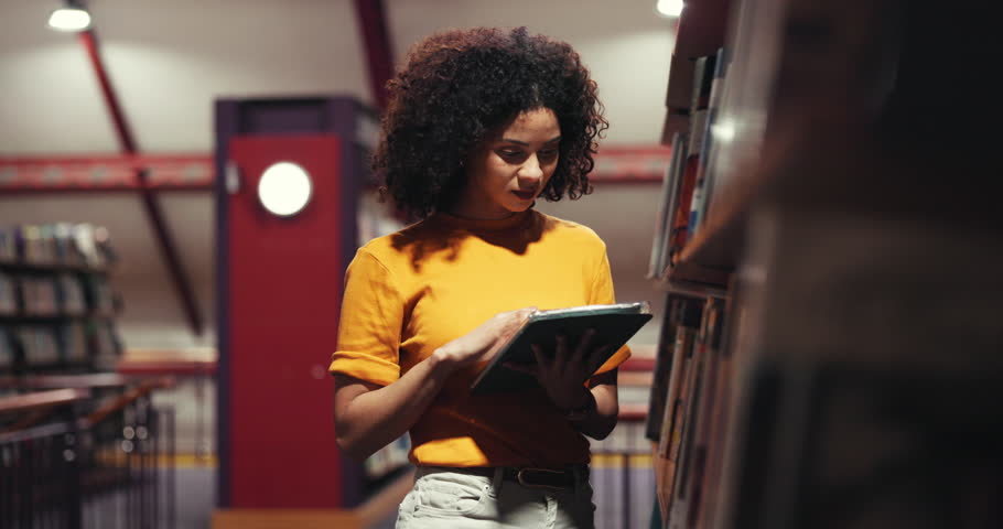 Woman, librarian and tablet in library for book search, shelf inspection and inventory management. Female person, digital and reading story titles for catalog, online checklist and website for stock