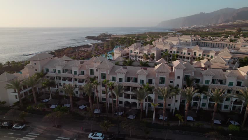 Luxury Beachfront Hotel Of Gran Melia Palacio de Isora With Palm Trees In Alcala, Tenerife, Canary Islands, Spain. - aerial shot