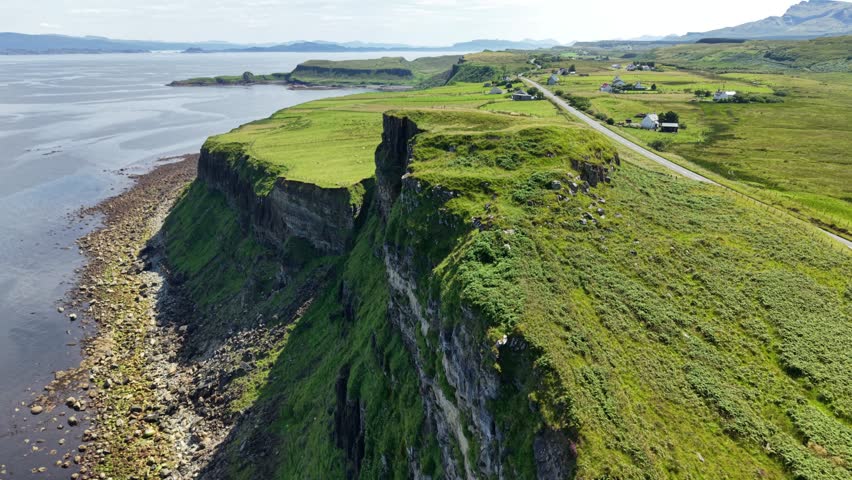 Breathtaking aerial views of the rugged isle of Skye showcasing majestic cliffs and serene coastal landscapes