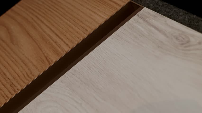 Extreme close-up abstract view of two contrasting wood grain textures, a light oak and a warmer brown, highlighting modern material choices and interior design surfaces