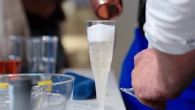 Close-up of a bartender pouring champagne or prosecco into a clear plastic flute, preparing a toast for a festive new year's celebration or party event - Powered by Shutterstock - Get 15% off with code: PIKWIZARD15