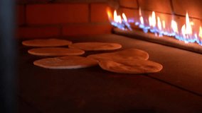 Flatbreads baking in a traditional oven, showcasing the cooking process with visible flames. - Powered by Shutterstock - Get 15% off with code: PIKWIZARD15