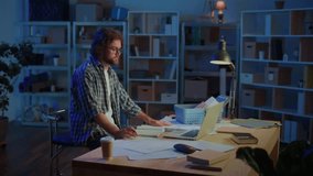 Man Talking Online at Desk Late at Night, Using Laptop in Home Office or Garage. Concept of Remote Work, Online Communication, Learning, Video Calls, and Staying Connected from Home at Night. - Powered by Shutterstock - Get 15% off with code: PIKWIZARD15