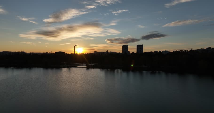 Sunset over city skyline and lake in Chișinău, Moldova