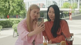 Two Smiling Women Blowing Kisses While Saying Goodbye On Video Call Outdoors - Powered by Shutterstock - Get 15% off with code: PIKWIZARD15