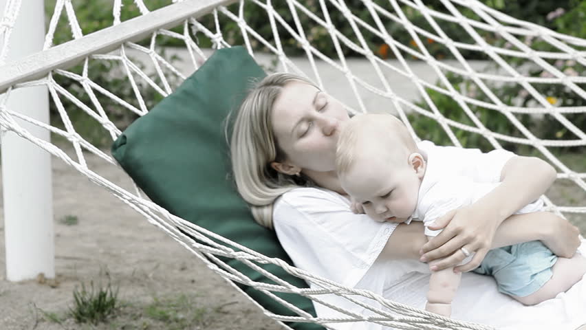 Happy baby with mother in hammock