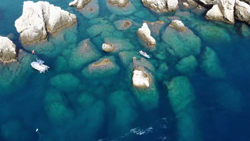 Aerial Drone View of Isola Bella Near Taormina, Sicily, Showing Tourists, Clear Water, Rocky Coastline, and Sunny Summer Atmosphere
