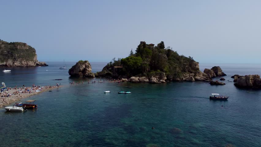 Aerial Drone View of Isola Bella Near Taormina, Sicily, Showing Tourists, Clear Water, Rocky Coastline, and Sunny Summer Atmosphere