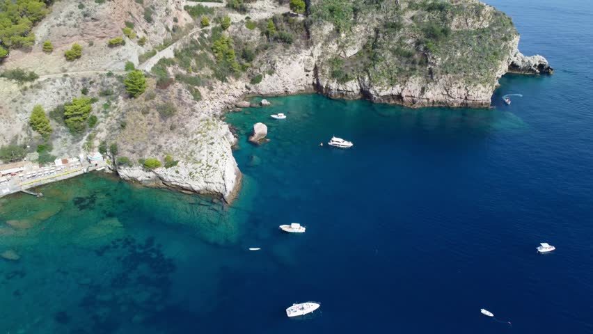 Aerial Drone View of Isola Bella Near Taormina, Sicily, Showing Tourists, Clear Water, Rocky Coastline, and Sunny Summer Atmosphere