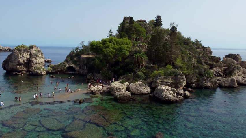 Aerial Drone View of Isola Bella Near Taormina, Sicily, Showing Tourists, Clear Water, Rocky Coastline, and Sunny Summer Atmosphere