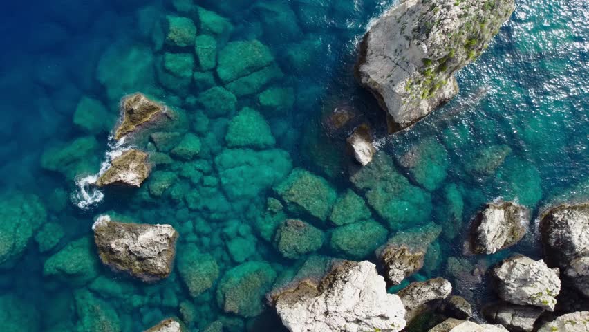 Aerial Drone View of Isola Bella Near Taormina, Sicily, Showing Tourists, Clear Water, Rocky Coastline, and Sunny Summer Atmosphere