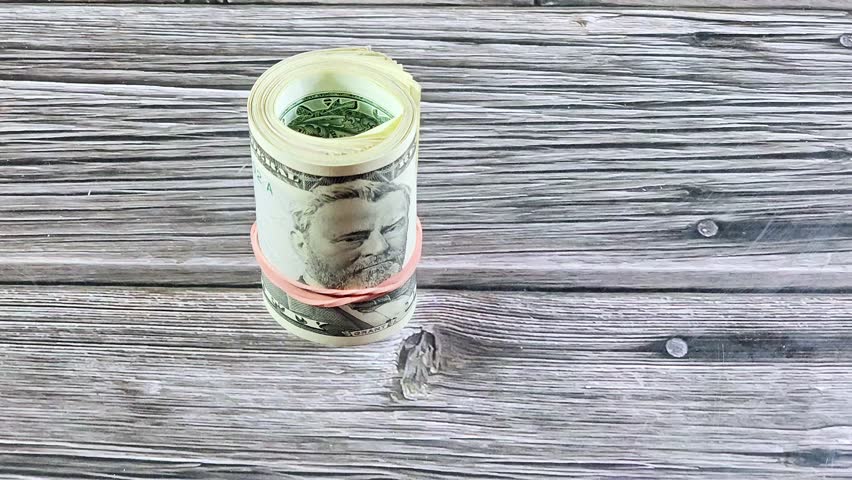 roll of 50 USD fifty American dollars banknotes cash money bills rolled up with a rubber band, features Ulysses S. Grant and the US capitol building, American money status concept, money exchange rate