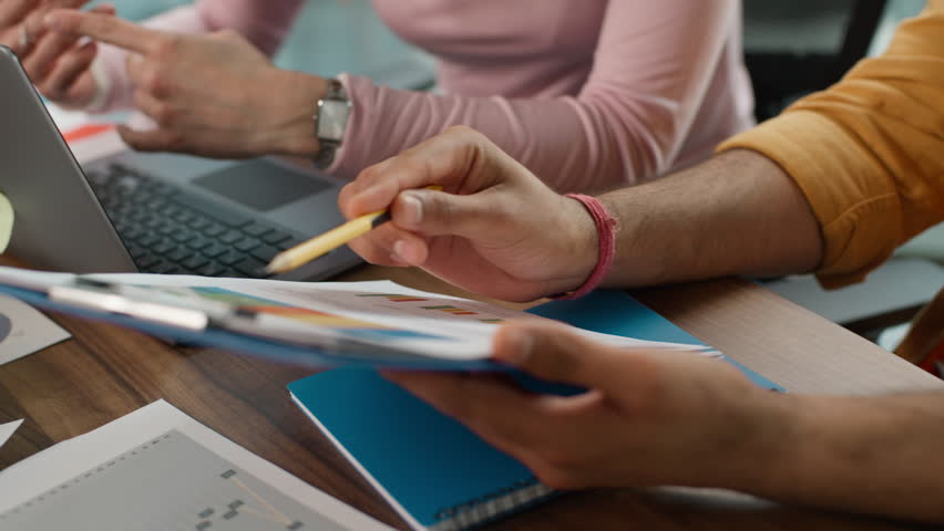 Business informal team brainstorming in office. Multiracial Arabian businessman talking happy Caucasian woman showing diagram stats carefree diversity colleagues discuss financial plan idea sharing - Powered by Shutterstock - Get 15% off with code: PIKWIZARD15