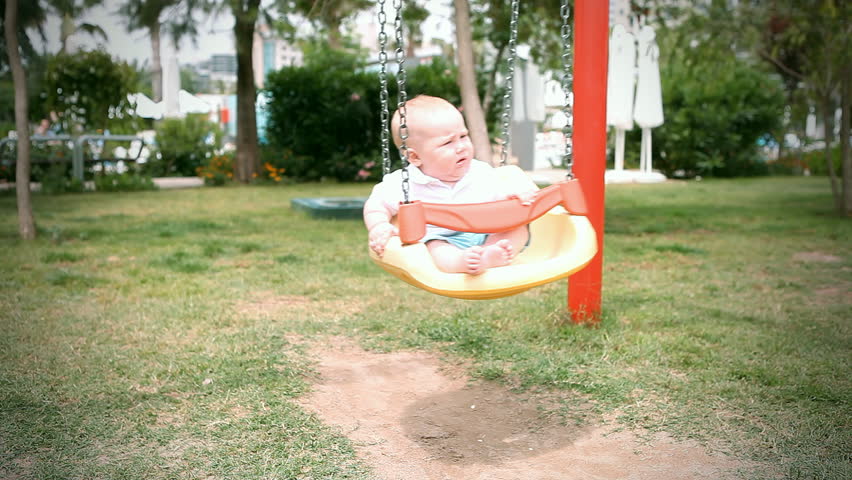 Baby in  swing outdoors