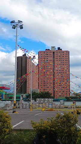 Facade of an apartment building with windows overlooking a parking lot at sunset in Bosa, Bogota, Colombia. Concept of architecture and real estate 