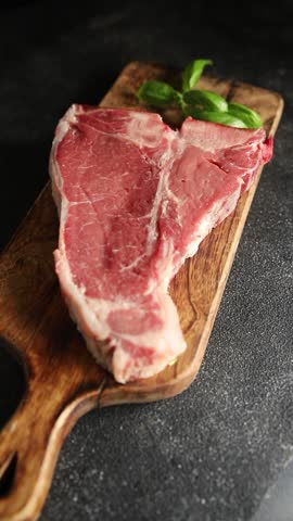 T-bone steak roast cut of meat juicy roast beef tasty snack fresh gourmet food background on the table rustic food top view copy space