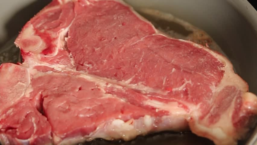 T-bone steak roast cut of meat juicy roast beef tasty snack fresh gourmet food background on the table rustic food top view copy space