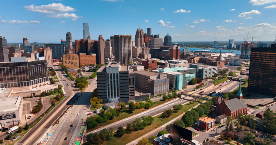 Multi-lane roads leading to the downtown of the city. Approaching the midtown of Detroit, Michigan, USA at daytime. Aerial perspective.