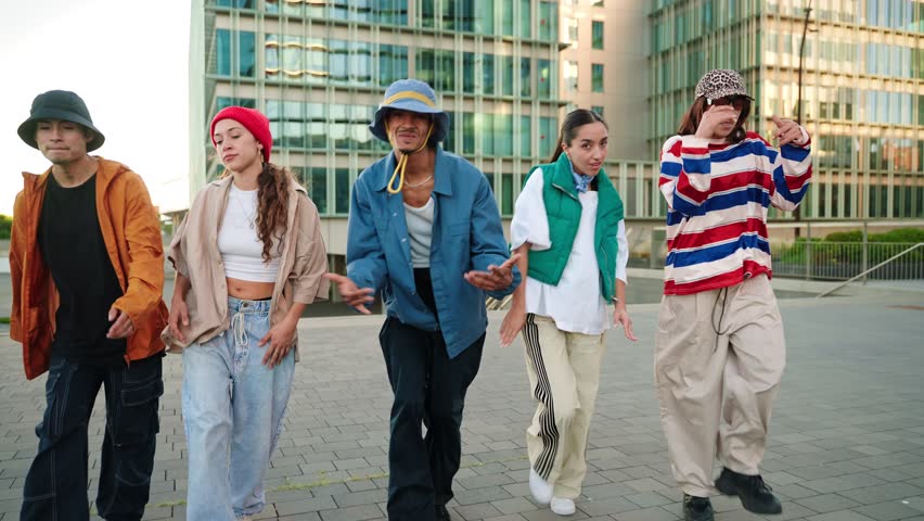 Trendy dancers walking and dancing in the city, having fun together expressing music, art, diversity and creativity