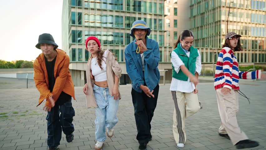 Trendy dancers walking and dancing in the city, having fun together expressing music, art, diversity and creativity