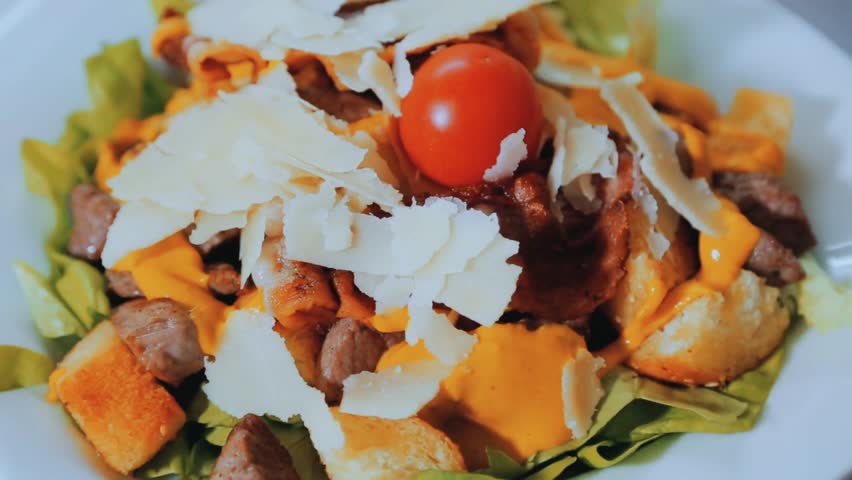 Portion of grilled meat with fresh salad turning on a white plate, symbolizing healthy eating, gourmet cuisine, and elegant food presentation.