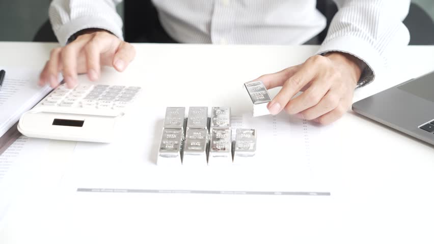 Silver Trading Businessman invest in trading silver, calculating profit price of silver in the market.