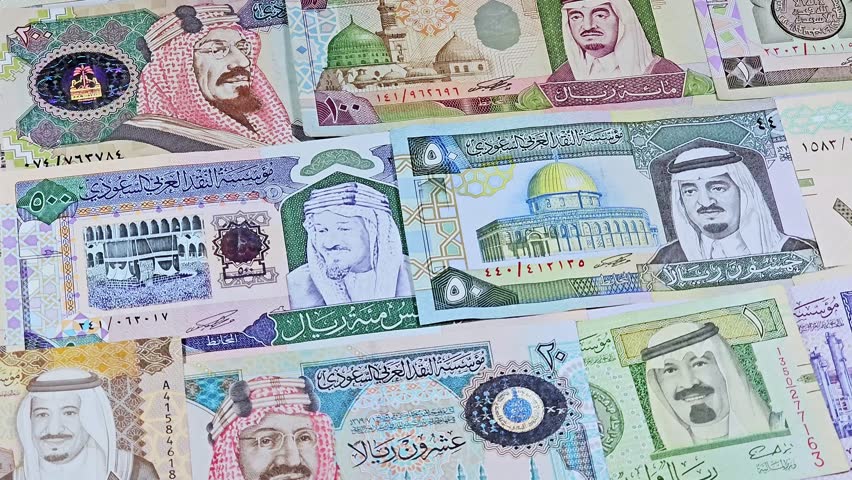 Saudi Arabian riyals SAR banknotes cash money bills, of different times, eras and values, from old vintage retro King Fahd times till king Salman time, Saudi Arabia riyals money and economy concept