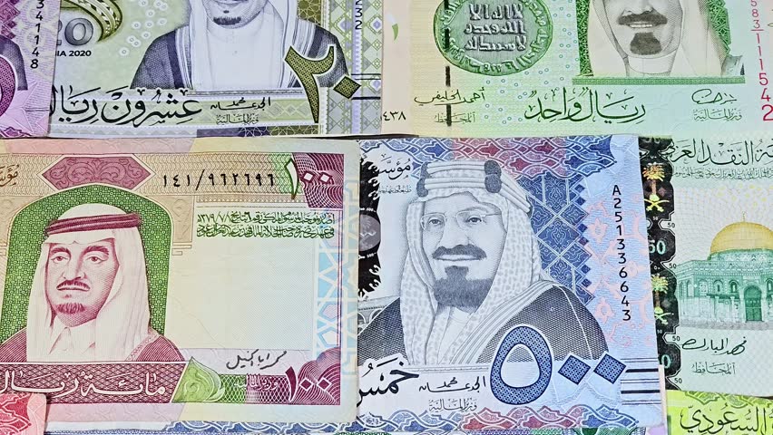 Saudi Arabian riyals SAR banknotes cash money bills, of different times, eras and values, from old vintage retro King Fahd times till king Salman time, Saudi Arabia riyals money and economy concept