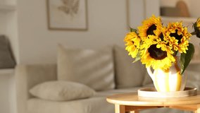 Beautiful sunflowers in vase on wooden table indoors, camera moving right - Powered by Shutterstock - Get 15% off with code: PIKWIZARD15