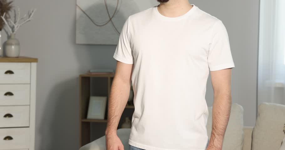 Young man wearing blank white t-shirt indoors, closeup