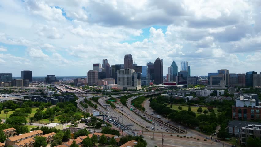 Daytime hyperlapse of downtown Dallas skyline with traffic. 