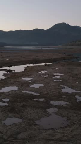 Drought-Stricken Landscape in British Columbia, Canada Reveals Parched Lakebed and Puddles